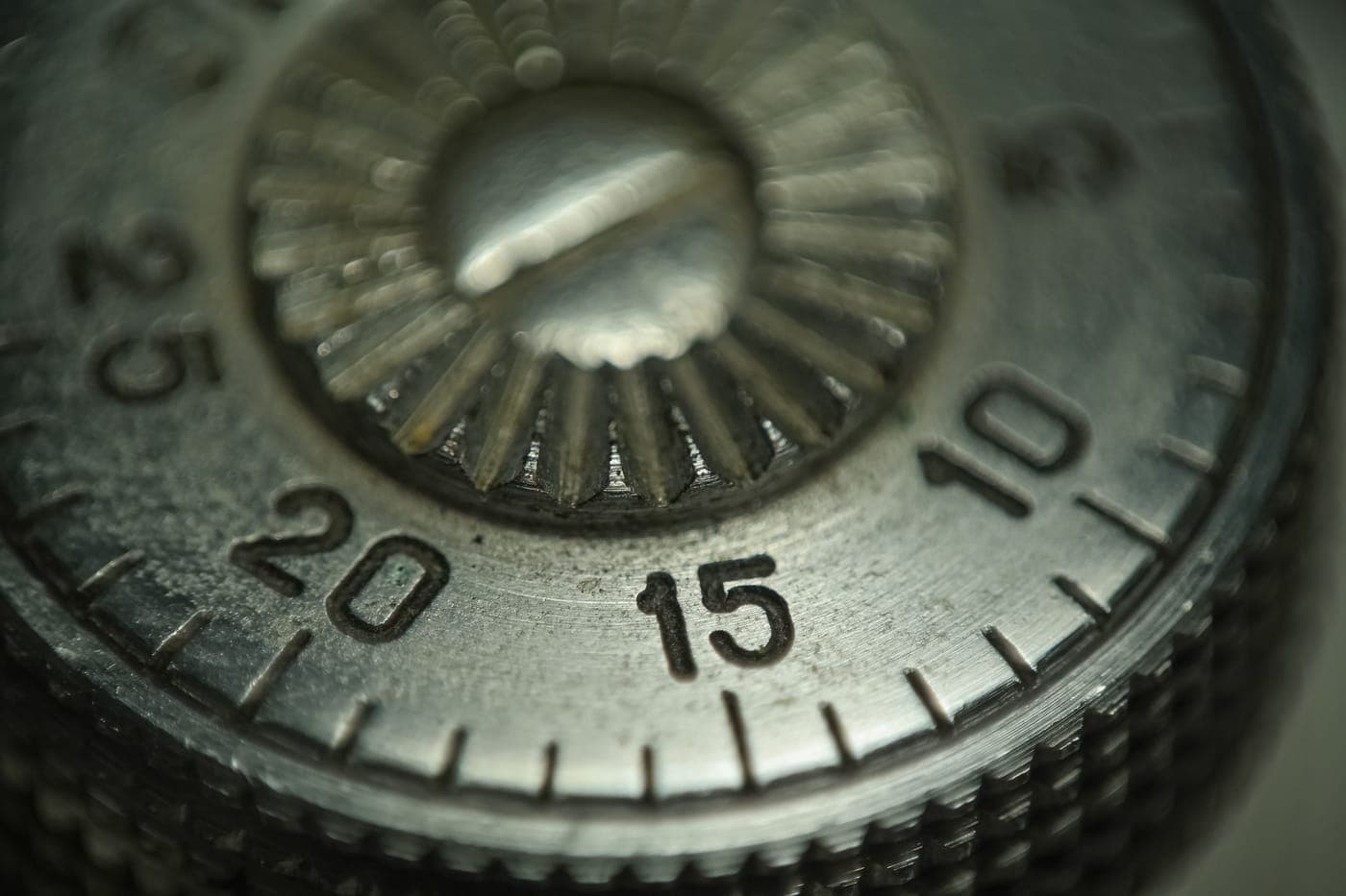 Macro shot of a metal combination dial and its numbered ring