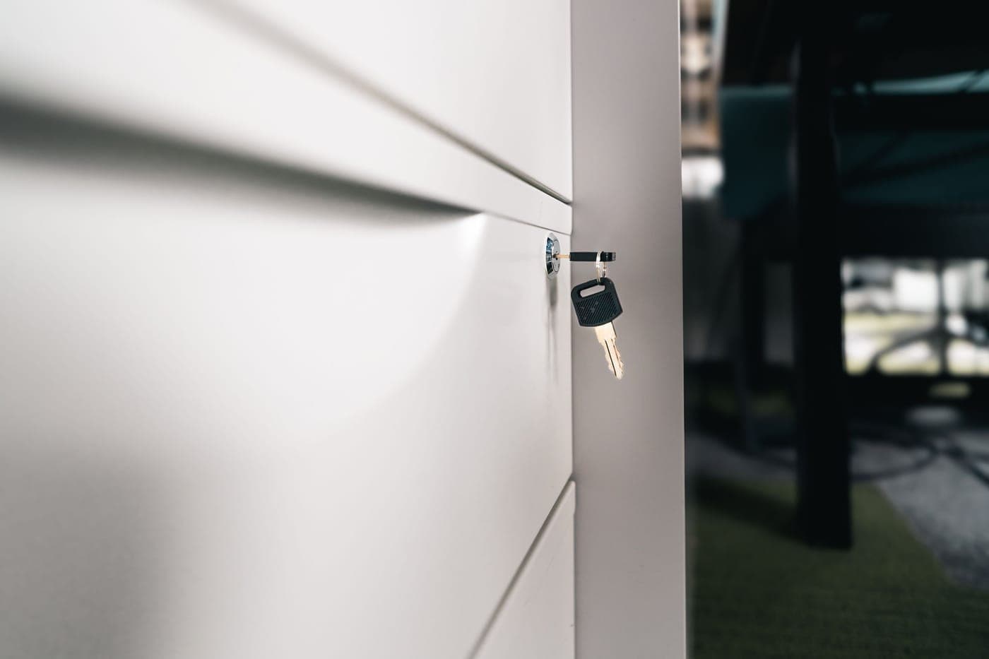 A key in the lock of a closed office drawer