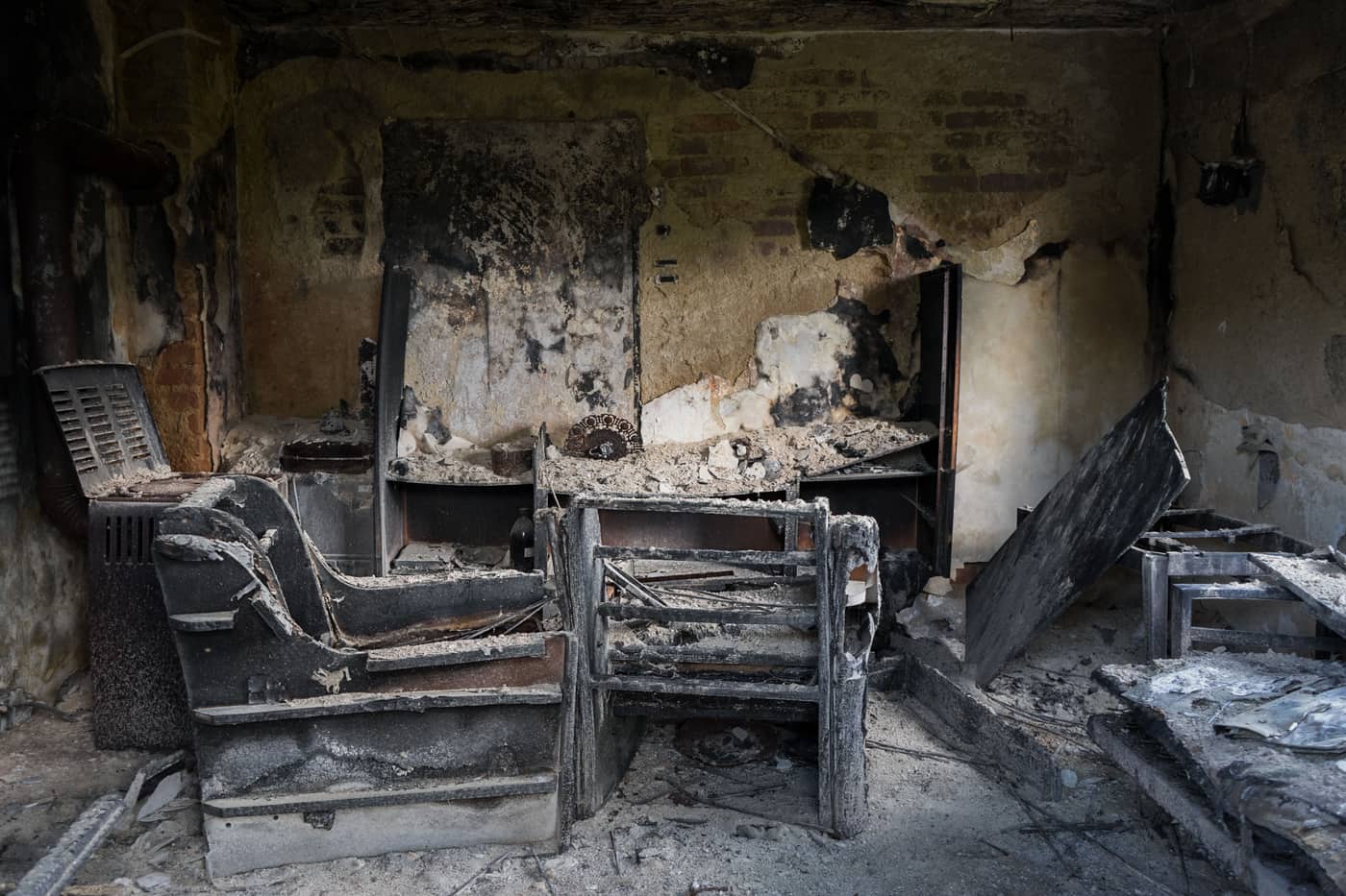 The charred interior of a fire-damaged room