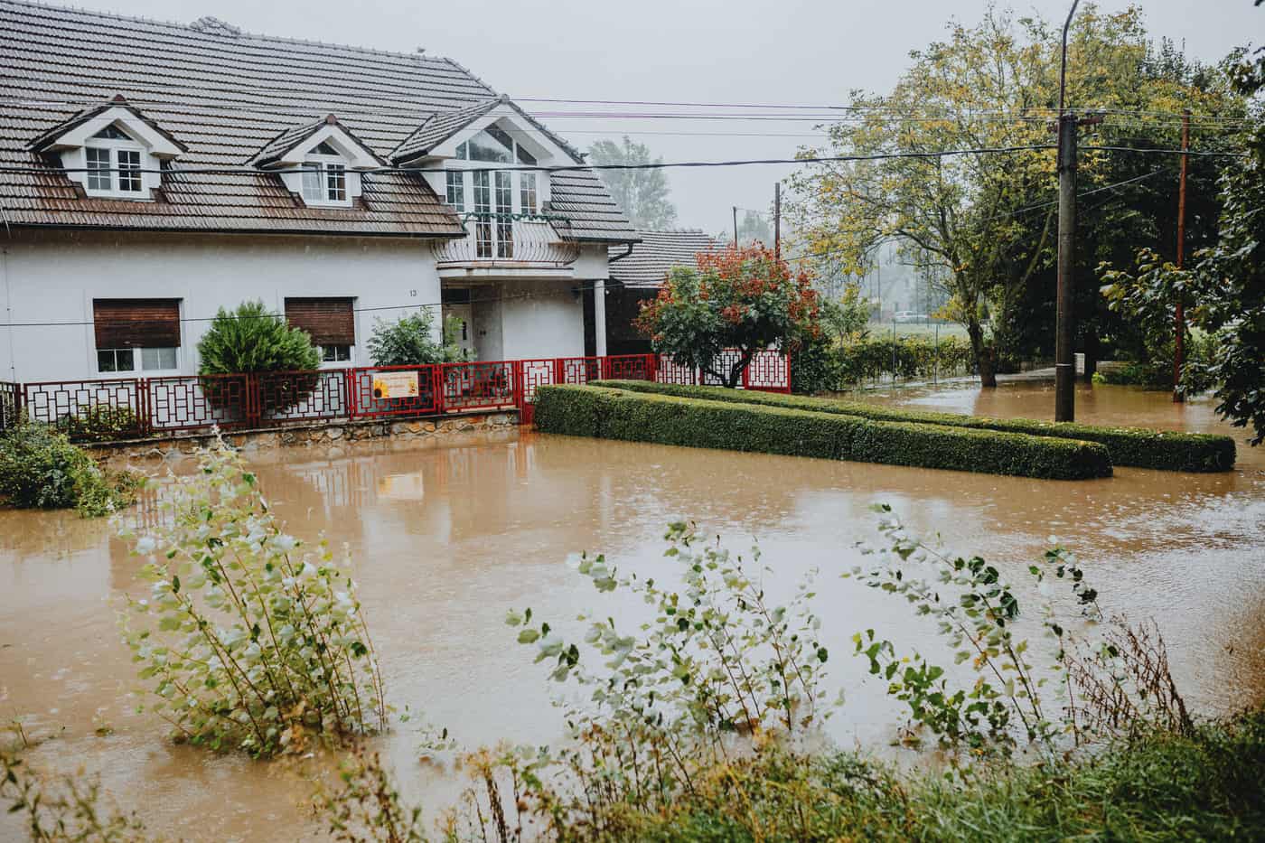 A suburban house surrounded by floodwater after heavy rain