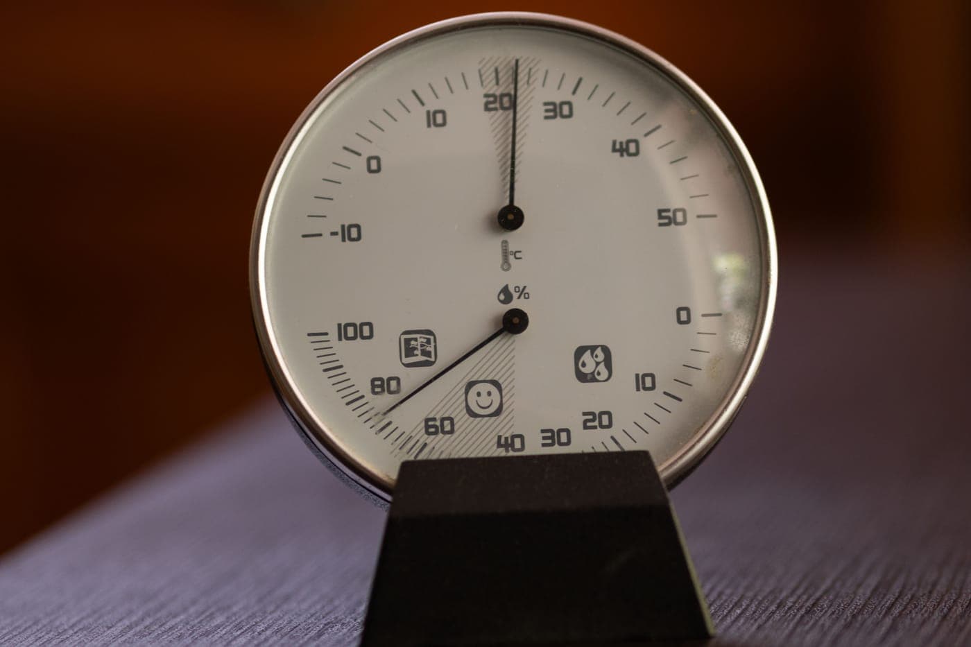 An analog hygrometer and thermometer showing indoor humidity